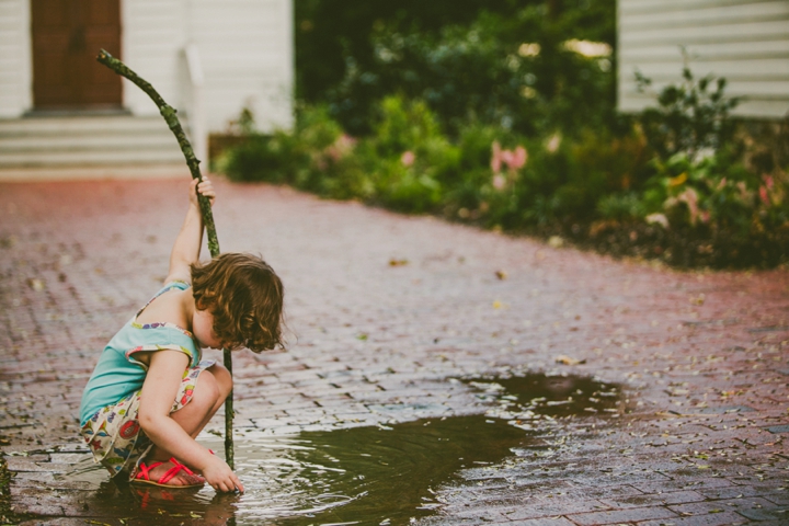 Kid playing in puddle