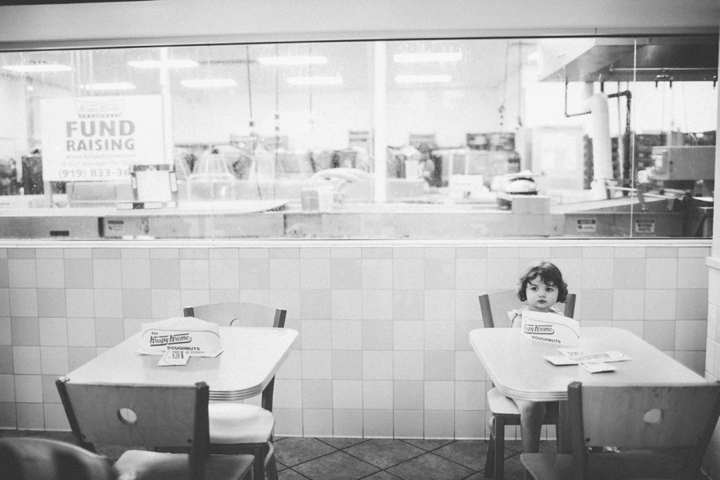 Kid sitting in donut shop