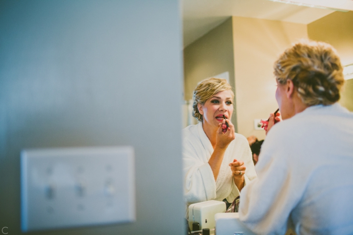 Bride putting on lipstick