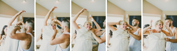 Bride putting on dress