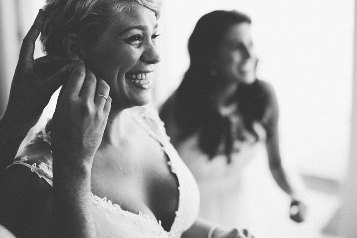 Bride putting on earrings