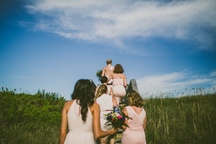 Bridesmaids walking up to the beach