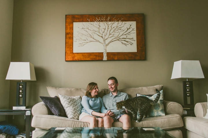 Couple sitting with cat on couch