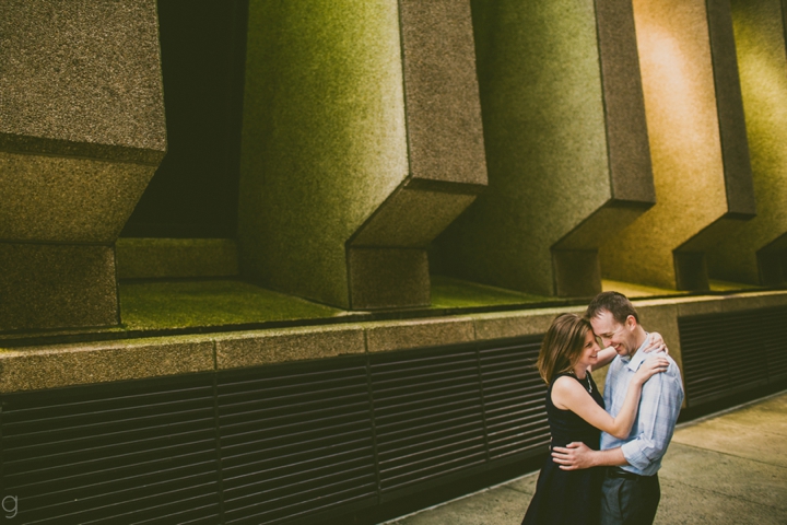 Couple cuddling by building