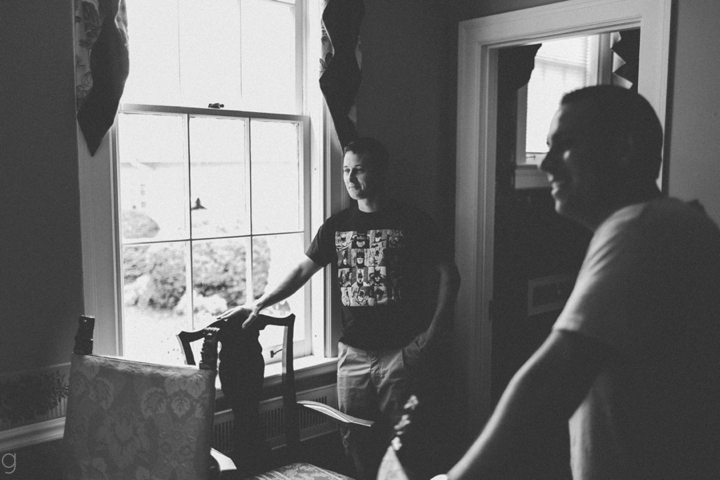 Groom standing by window