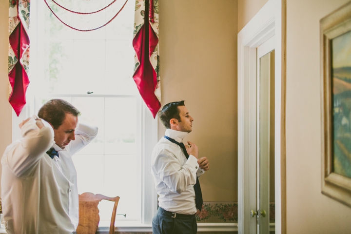 Groom tying tie