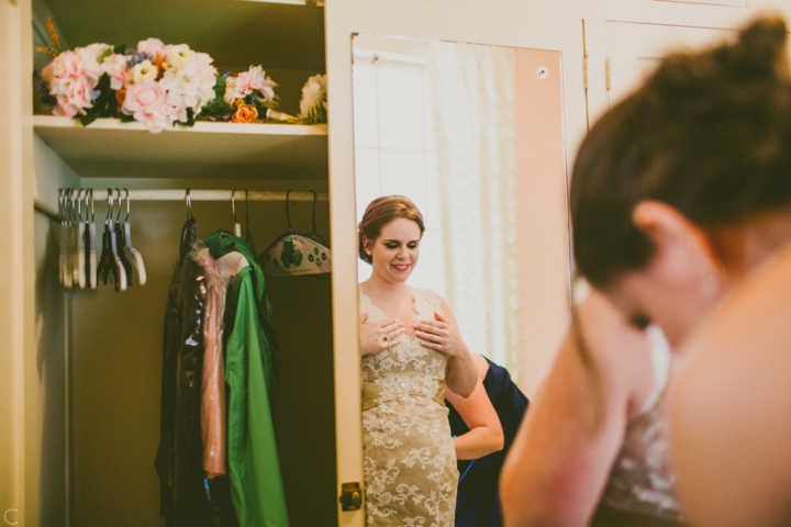 Bride putting on dress