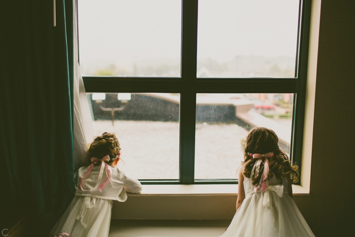 Flower girls looking out window