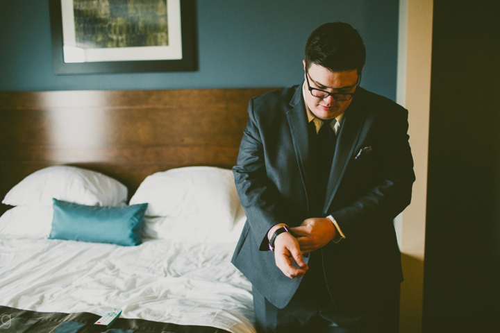 Groom buttoning jacket