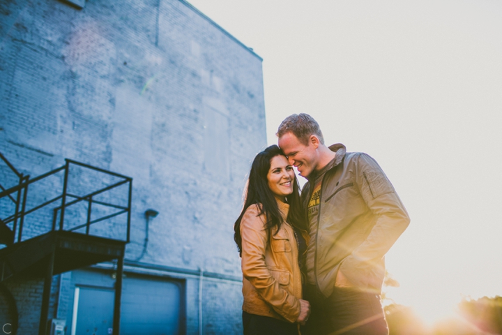 Couple cuddling by building