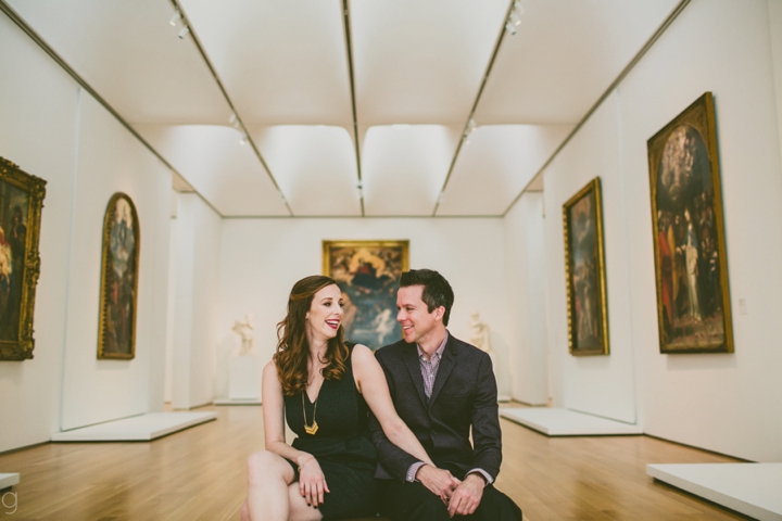 Man and woman sitting in art gallery