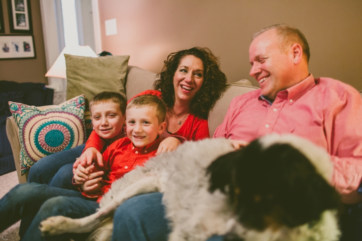 Family laughing on couch