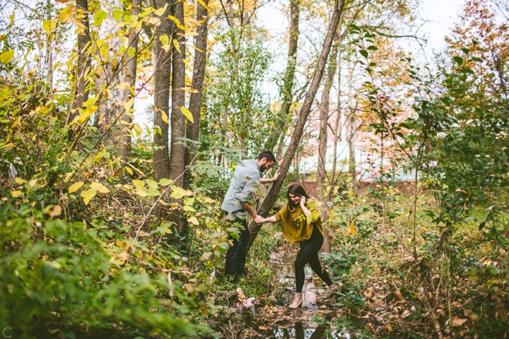 Husband helping wife across creek