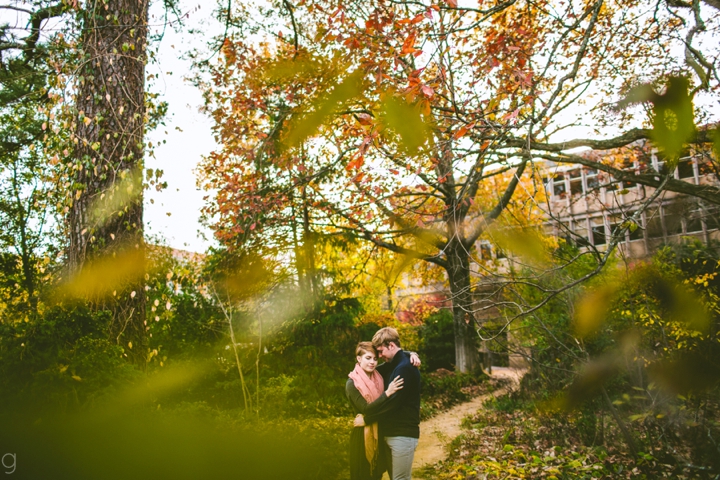 Couple hugging at UNC arboretum during engagement session