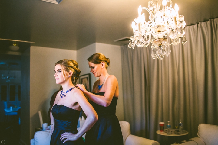 Bridesmaid putting on dress