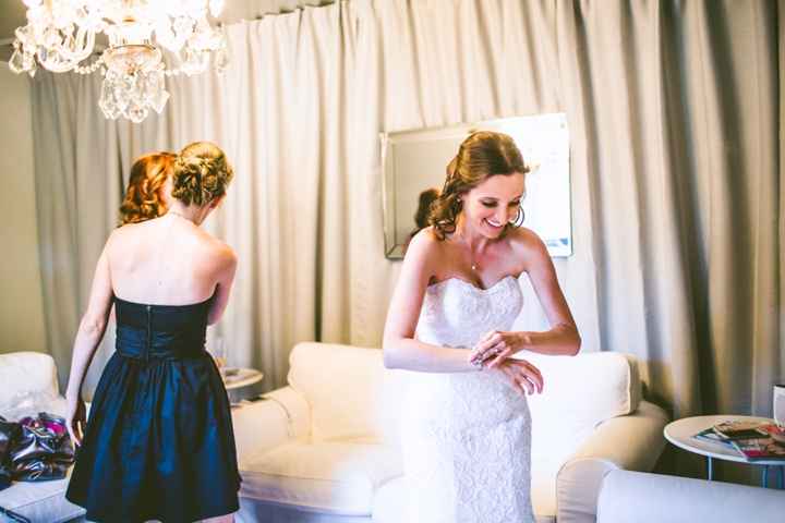 Bride laughing while getting ready for wedding