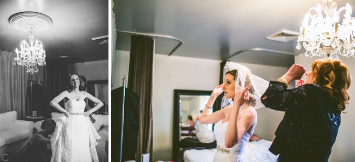 Bride putting on wedding veil