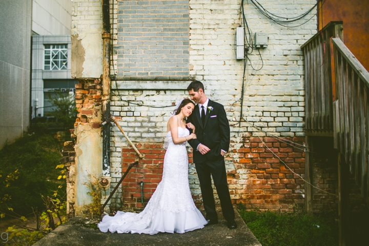 Husband and wife posing for wedding photographers