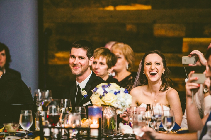 Couple laughing during toasts at wedding