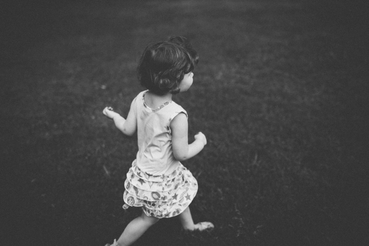 Girl running through grass