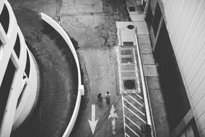 Black and white photograph of couple walking in downtown Durham