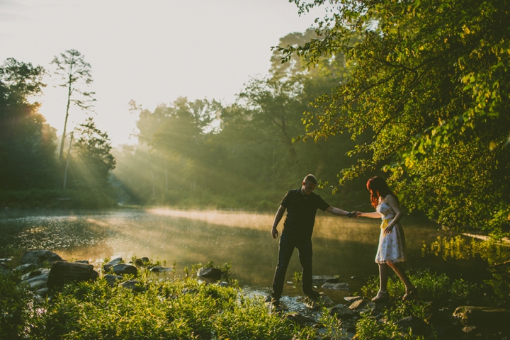 Couple walking through water during engagement photos