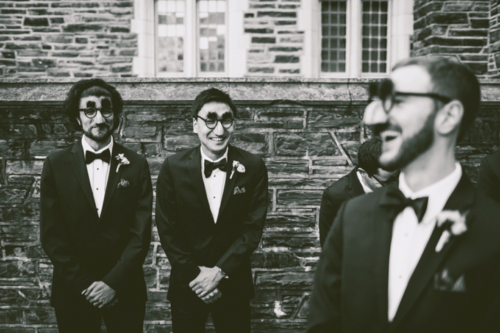 Black and white groomsmen wearing funny masks