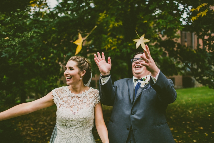 Couple throwing leaves in air at Pittsburgh wedding