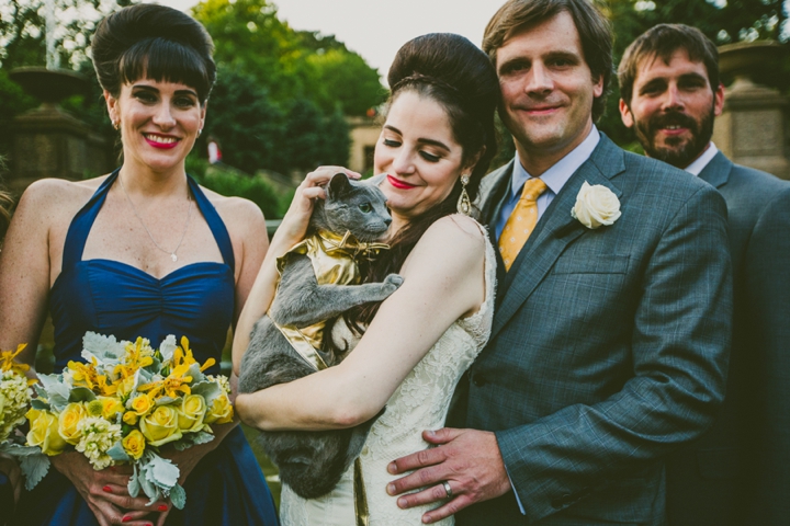 Couple holding cat at wedding