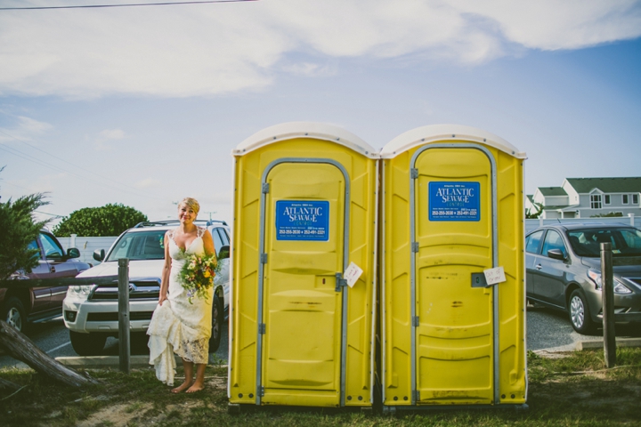 Bride standing by porta potty