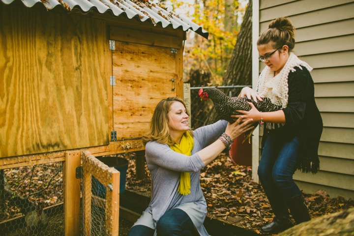 Mother handing chicken to daughter