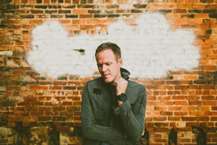 Man holding collar of shirt for headshots