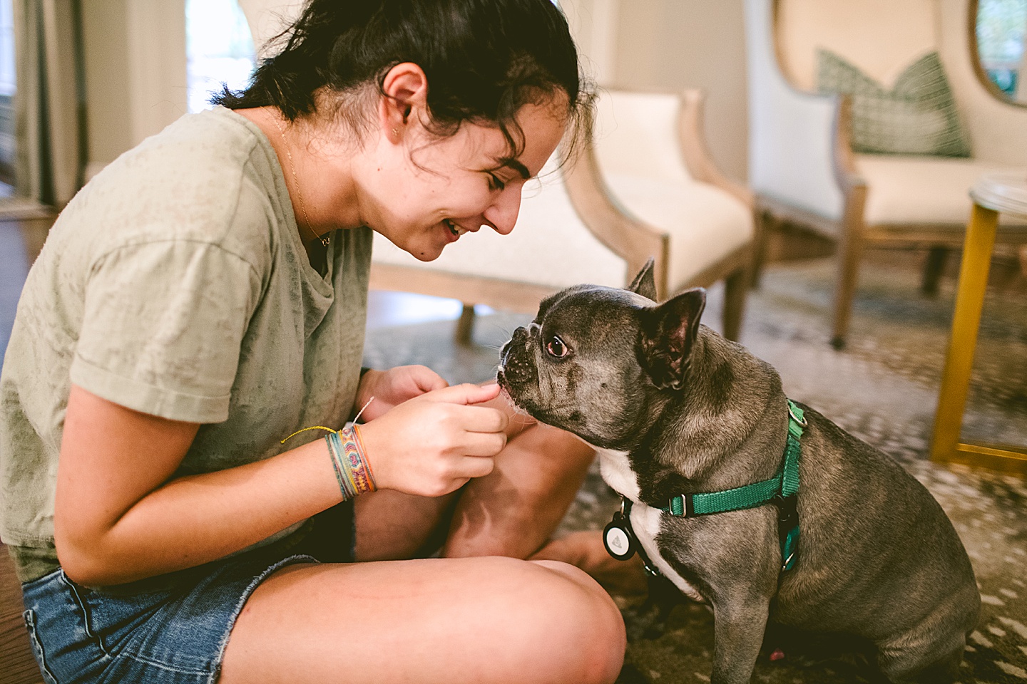 Girl sitting with French bulldog