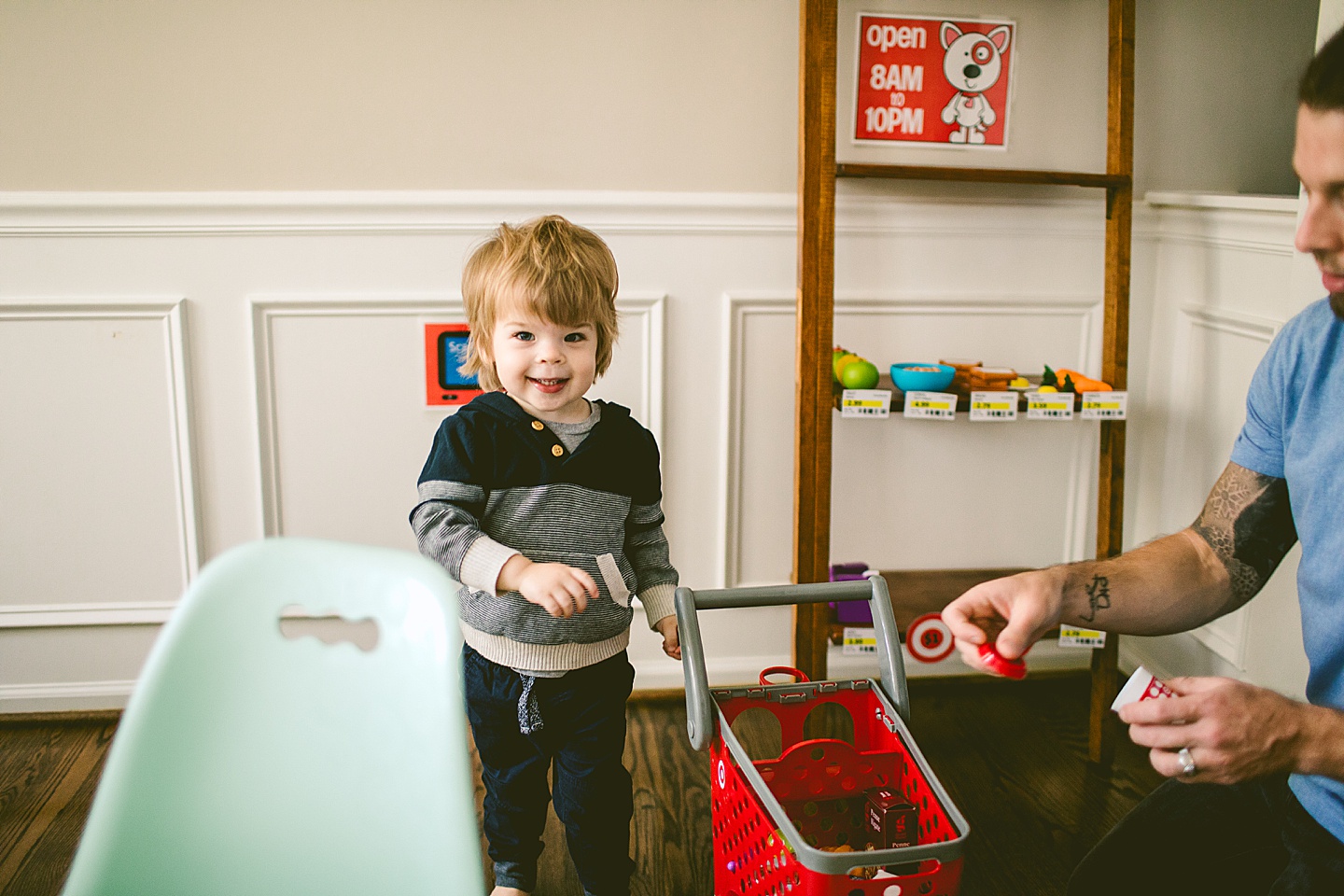 Kid shopping with mini Target shopping cart toy