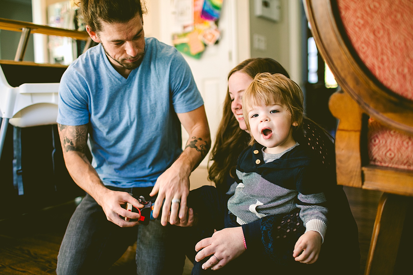 Parents helping child put on his shoes