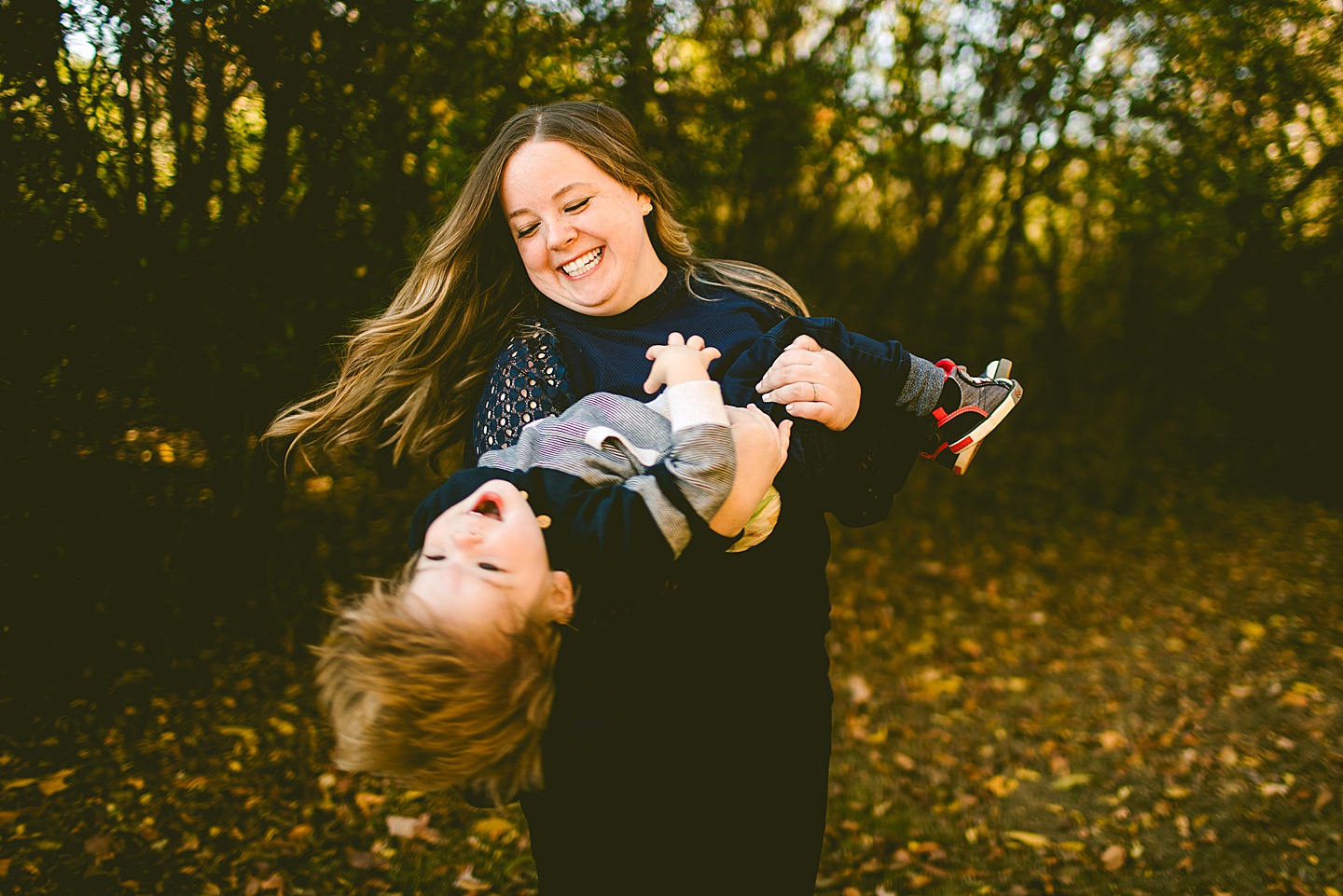 Mom spinning toddler son around