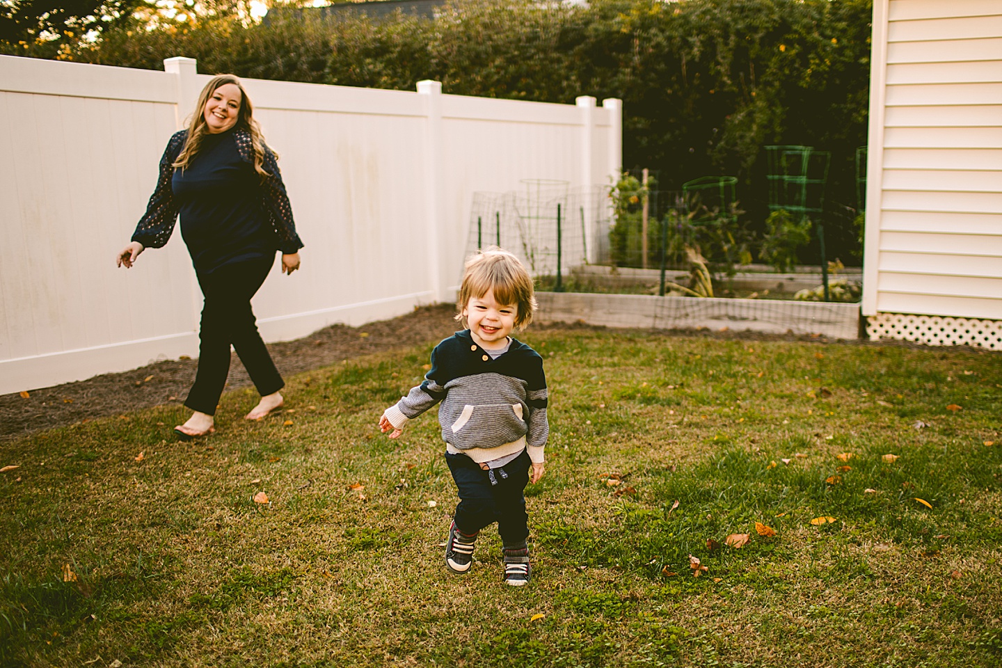 Kid running through his yard during family portraits