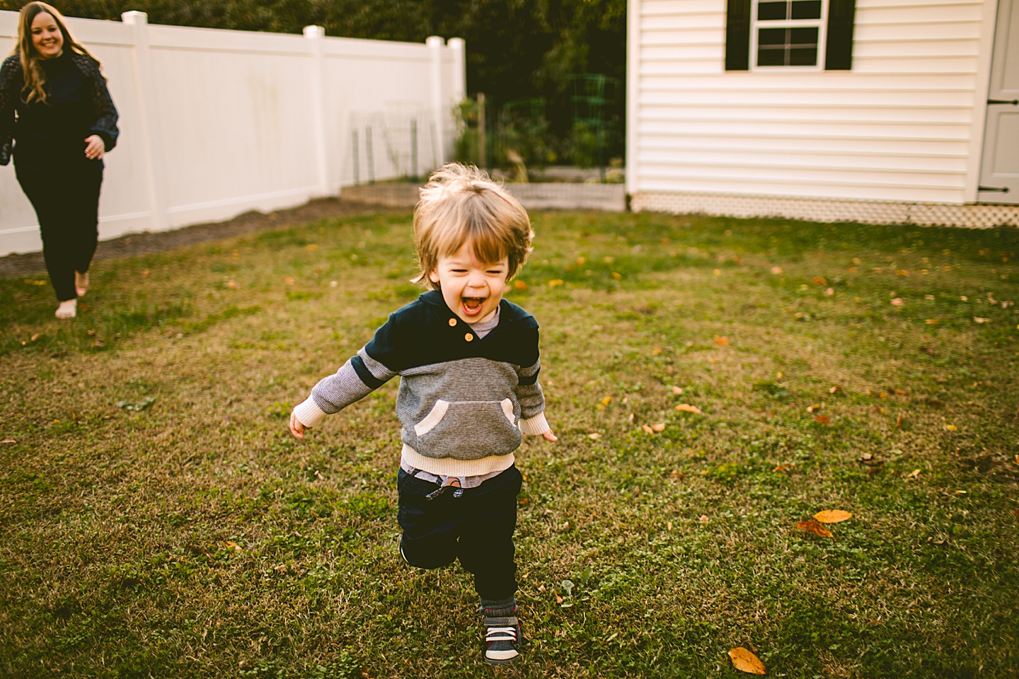 Kid running through his yard during family portraits