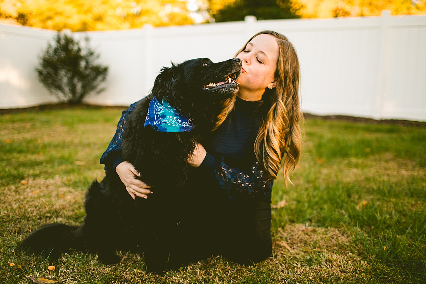 Woman kisses dog in portrait