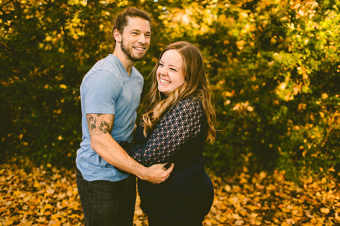 Couple laughing with the fall leaves