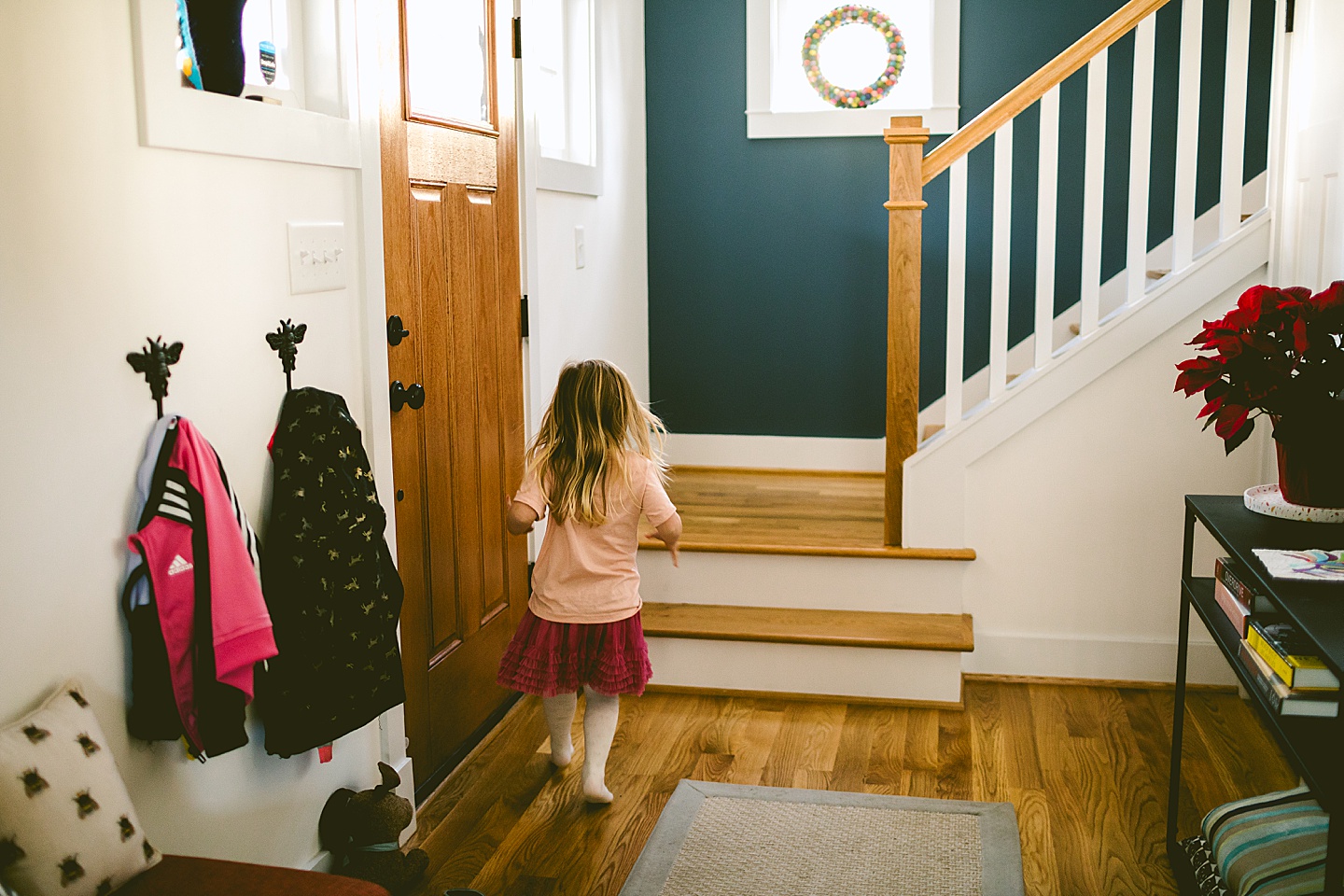 Girl running up the stairs in her home