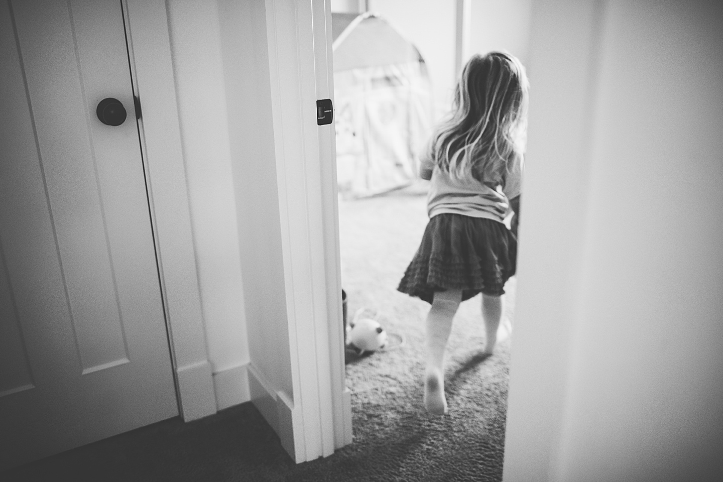 Black and white image of little girl running