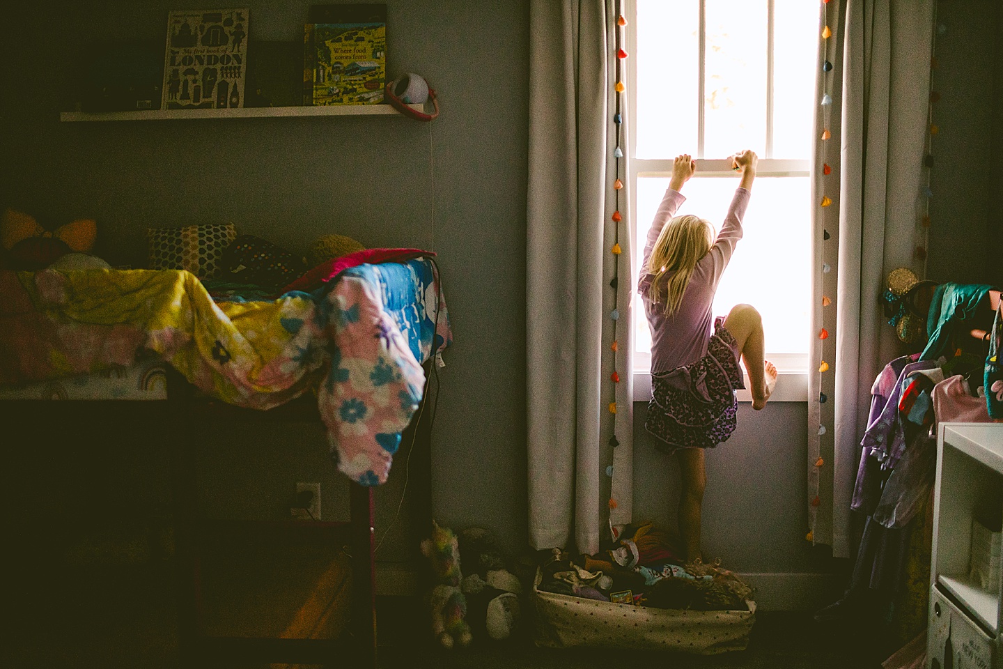 Picture of girl climbing on her window sill