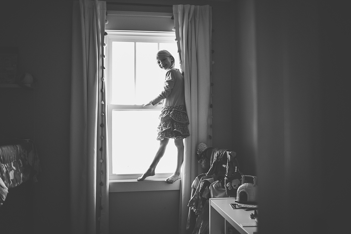 Picture of girl climbing on her window sill