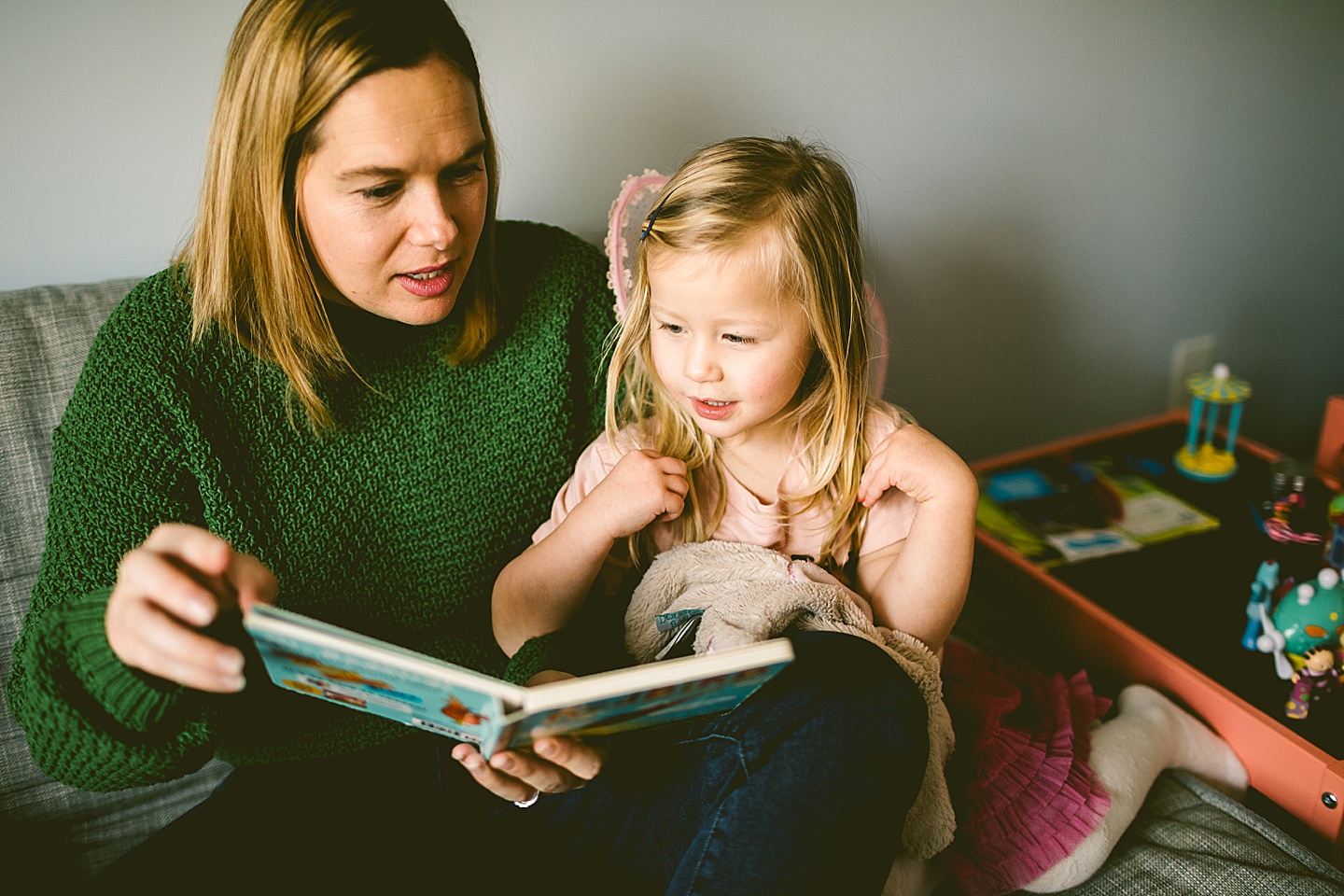 Mom reads a book to her daughter