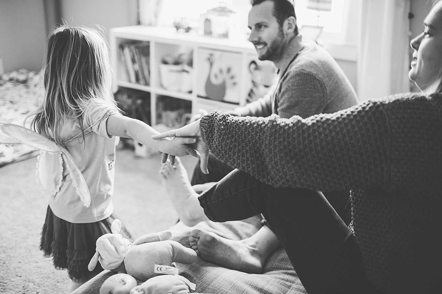 Girl holding her mom's hand in black and white photograph