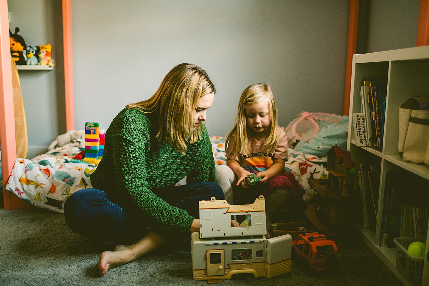 Mom playing with toys with daughter