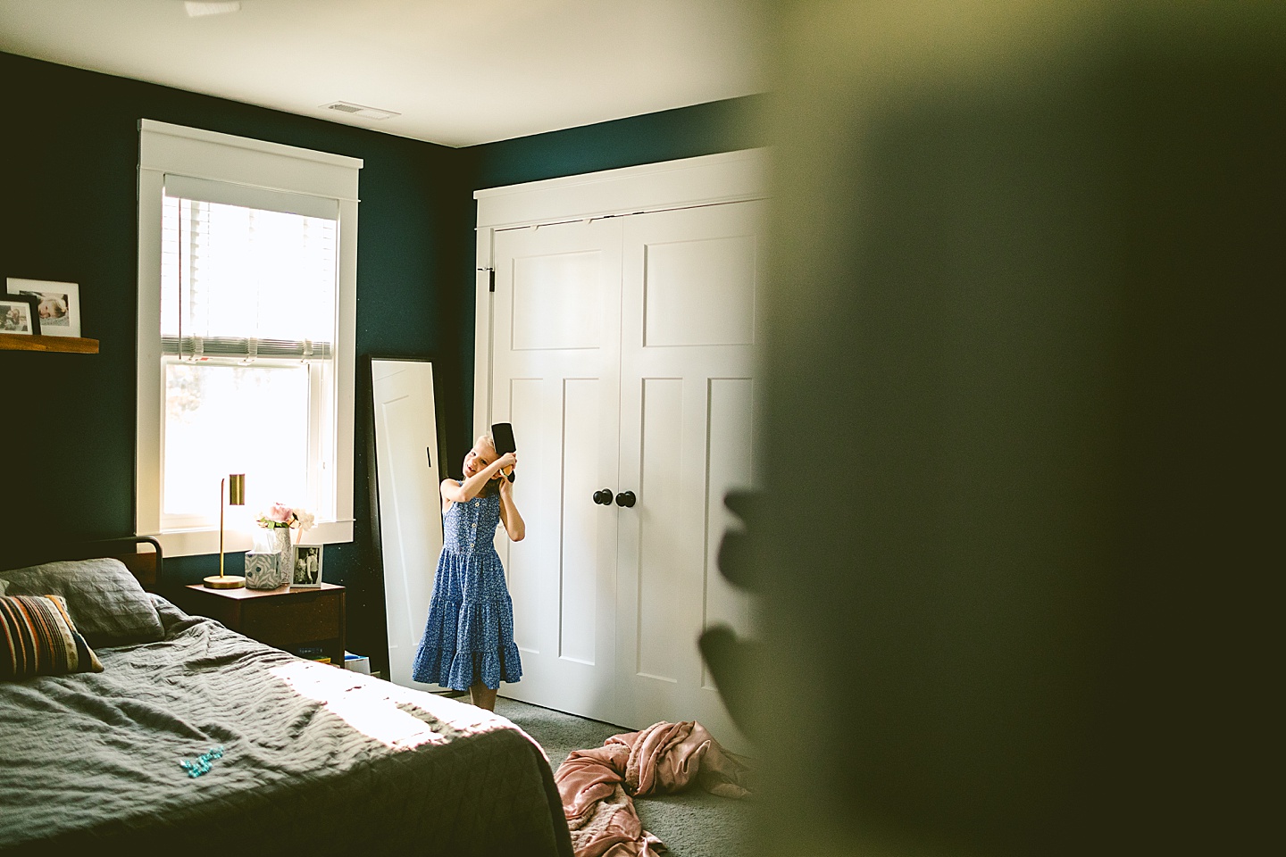 Girl brushing her hair in mirror