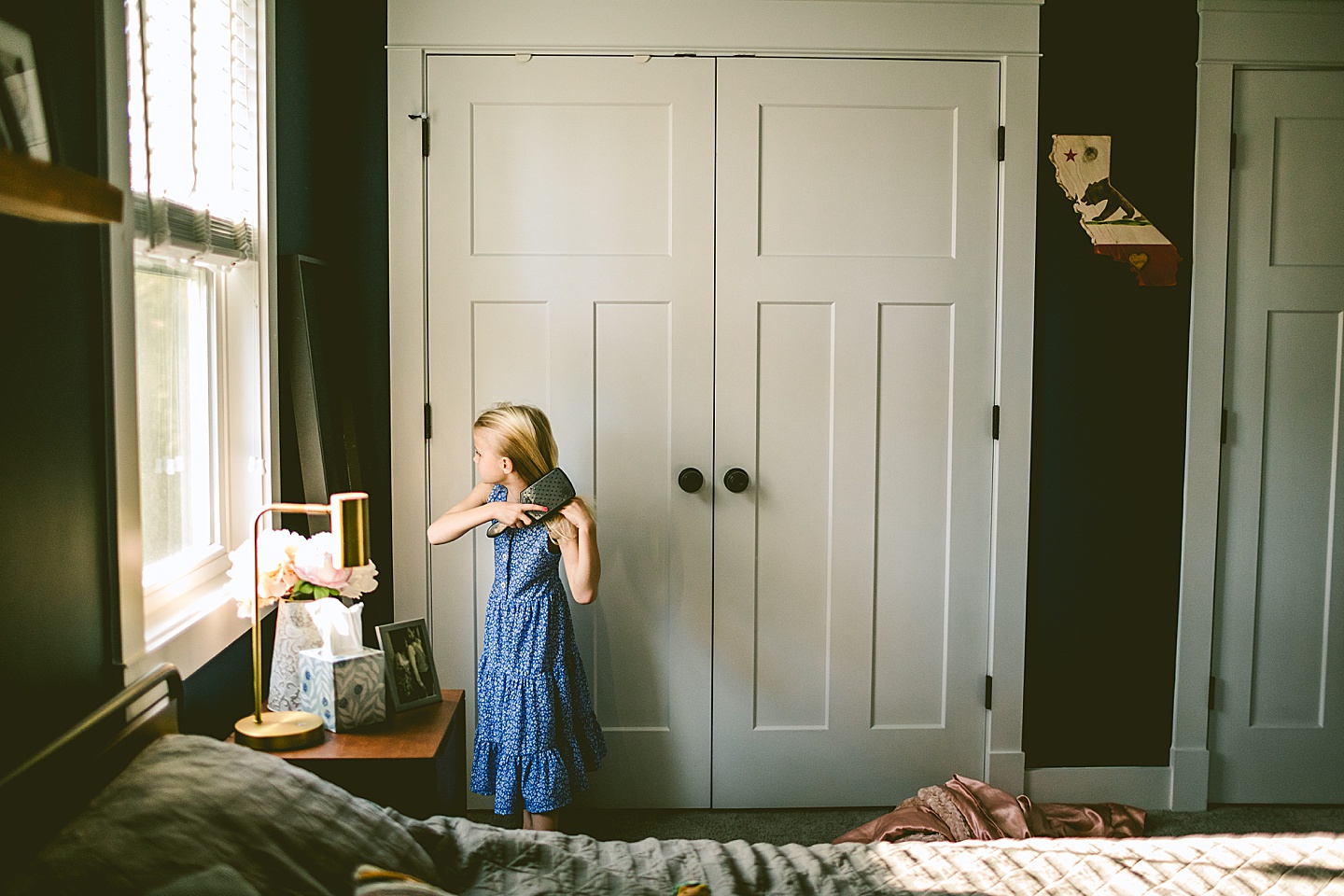 Girl brushing her hair in mirror