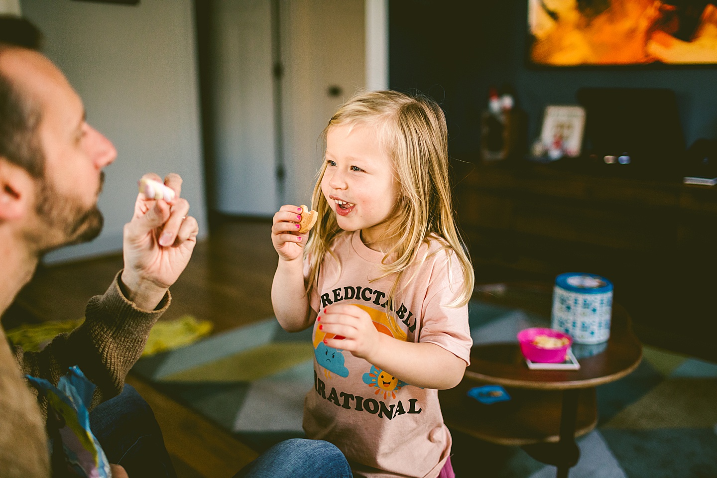 Daughter smiling at her dad in living room